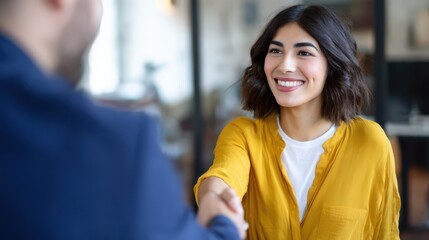 an attractive woman shaking hands with someone in an office setting