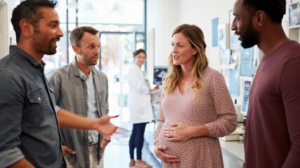 Pregnant woman discussing embryo transfer with group and couple in clinic during procedure preparation with care and hope - Powered by Adobe