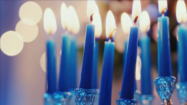 A row of blue candles on a menorah, symbolizing the traditional Hanukkah lighting ceremony.
