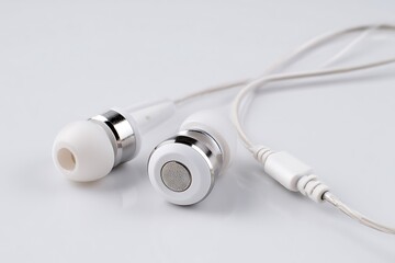 Modern white earbuds with silver accents offer crystal-clear audio for music, podcasts, or calls, perfect for travel or work