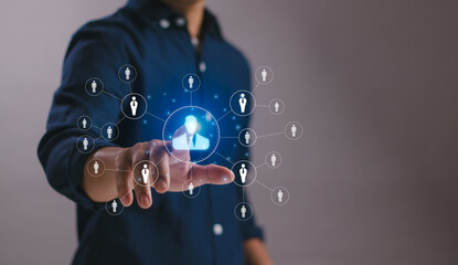 Concept ofHuman resource management , recruitment, HR,HRM, personnel selection, organizational leadership, businessman finger touching human resources with icons in virtual graphics