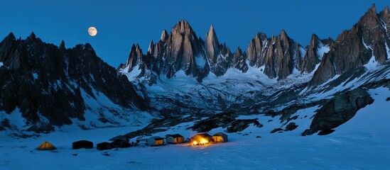 Snowy mountains at twilight with tents