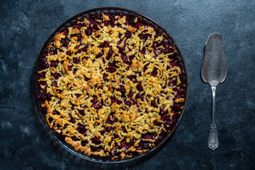 Baking dish with tasty cherry pie, closeup, top view. Delicious homemade pie with fresh red cherries on table. Summer shortcrust pie with berries