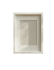 Empty, light beige picture frame,  shadowed by sunlight