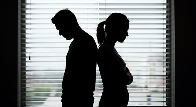 Couple silhouette standing back to back depicting conflict and separation