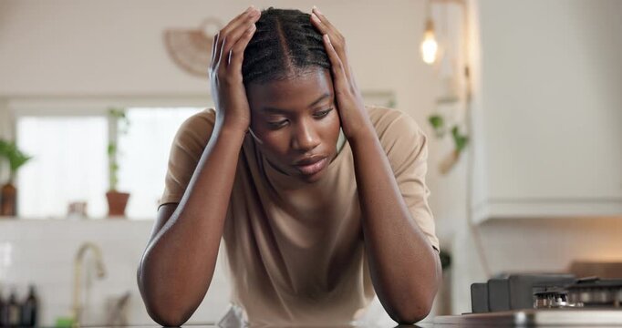 Black woman, headache and stress with depression in kitchen for overworked, strain or pressure. Female person, mental health and tired with pain or migraine for fatigue, burnout or burden in home