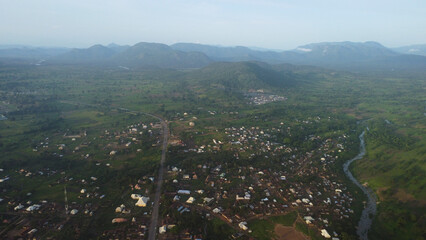 Scenic Aerial View of Rural Landscape with Winding River and Distant Mountains, Featuring Small Village