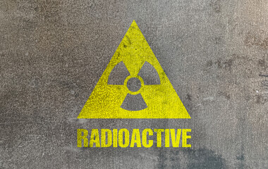 Obraz premium Radioactive sign on grey textured surface. Radiological pollution