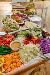 A Colorful Array of Fresh Salads and Vegetables Displayed on a Buffet Table, Featuring An Abundance of Crisp Ingredients Perfect for Healthy Eating.