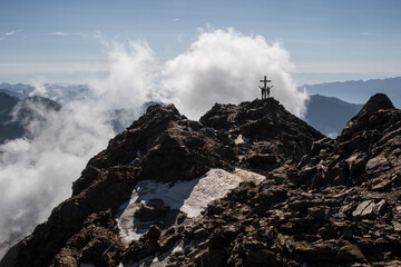Next to the summit of Vioz Mount , with clouds and distant mountains in the background. The refuge Mantova is a starting point for climbing the Vioz peak.