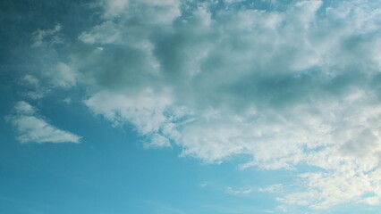 A Beautiful, Serene Blue Sky with Fluffy White Clouds Gracefully Floating Above in Calm Harmony