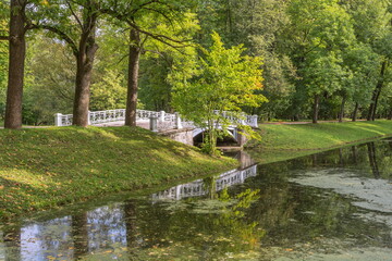 White lace bridge over the river in the park