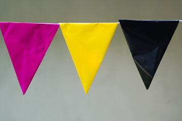 Colorful Triangular Bunting Flags: Pink Yellow and Black Party Decorations.