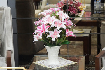 Pink and White Lilies in Elegant Vase on Glass Coffee Table.