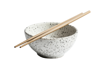 Ceramic bowl with chopsticks isolated on transparent background. Pair of bamboo chopsticks placed across a speckled ceramic bowl isolated on white background.