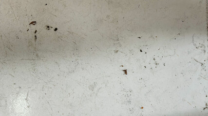 White Surface with Scratches and Debris.
