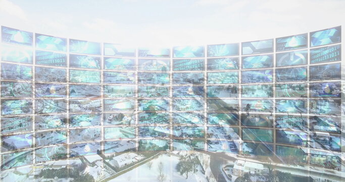 Displaying curved monitor wall projecting binary code and globes in control room over snowy suburb