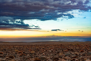 The immense and arid landscape of the Salar de Atacama, Chile, showcasing the unique beauty of the high-altitude desert at sunrise or sunset.