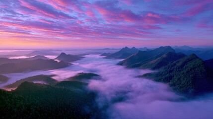 Obraz premium Aerial view of misty mountain peaks at dawn, orange and pink hues in the sky, untouched wilderness, serene and majestic natural scenery, stock photo for adventure themes