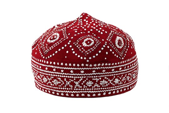 Intricate ajrak Kufi hat design with symmetrical geometric patterns and white embroidery details on a red background, perfect for cultural projects