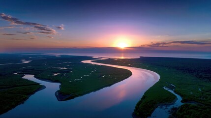 Fototapeta premium Drone footage of a river delta at sunset, shimmering waterways and green wetlands, rich habitat for wildlife, atmospheric and scenic, documentary stock photo