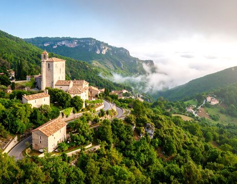 Mountain village nestled in valley at sunrise - Powered by Adobe