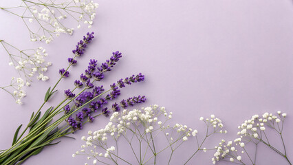 Lavender sprigs and delicate baby's breath scattered on pale purple surface creating romantic spring arrangement with natural shadows and textures.