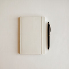 Blank White Notebook and Black Pen on White Background