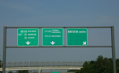 highway sign with major italian cities including brescia milan varese como turin and bologna in northern italy