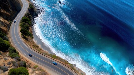 Fototapeta premium Top-down aerial of winding coastal road, cars driving along cliffside, dramatic ocean views, freedom and travel inspiration, perfect for journey stock photo