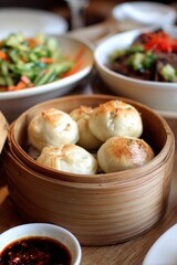 Steamed buns in bamboo basket along with a dipping sauce and salads