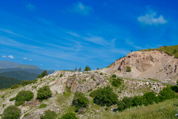 Scenic mountain landscape with a blue sky and rocky terrain in a peaceful setting