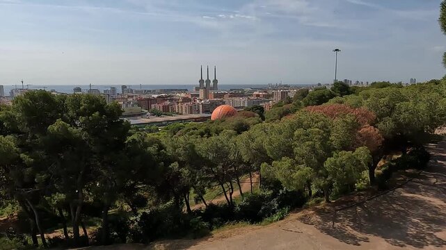 Badalona, Spain-23 August 2024. Panoramic view of the energy towers in Badalona, Spain, from a nature park. The harmony between nature and industry captured from a park overlooking three chimneys.