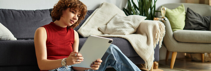 Curly-haired young woman enjoying a relaxed afternoon in her stylish apartment
