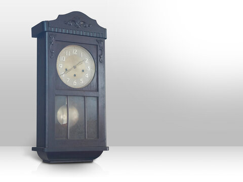 Antique and old brown color wall clock on gradient white and grey background, object, technology, decor, ancient, old, fashion, copy space
