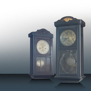 Antique and old two brown and black color wall clocks on black floor, gradient white and grey wall,background, object, technology, decor, ancient, old, fashion, copy space