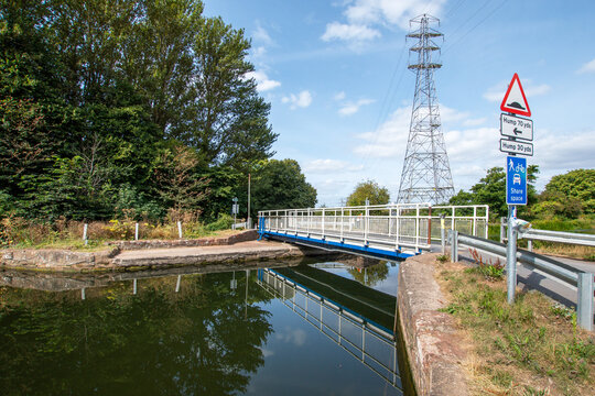 Exeter canal with a small bridge crossing the flat calm canal. Good copy space.