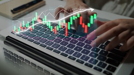 A close-up view of a laptop keyboard with hands typing, featuring stock market graphs and data visualizations, symbolizing finance and trading activities. Copula