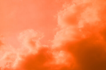 Orange sky with white clouds. The phenomenon of evening light, the sun is setting on the horizon. Summer is a hot day with beautiful natural light.