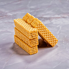 Vanilla wafer cookies stacked on marble background