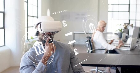 Putting on VR headset, male coworker manipulating finance icons in office for currency analysis - Powered by Adobe