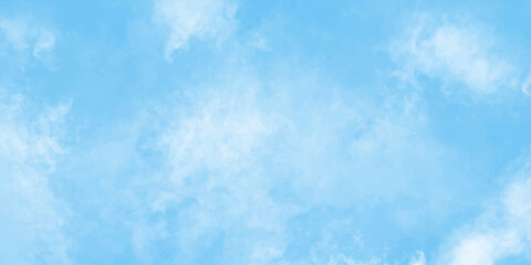 Fluffy white clouds drift across a bright blue sky on a clear summer day
