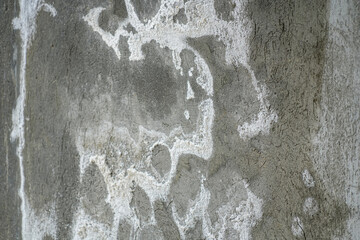 Rough, textured concrete wall details with distinctive white stains caused by efflorescence or salt...