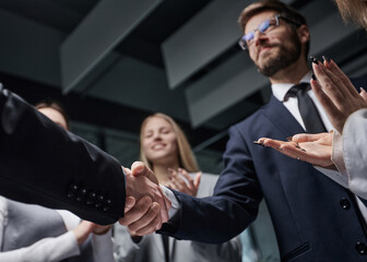 A group of people in suits shaking hands