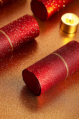 Three red glitter Christmas crackers and a lit candle on a shimmering gold surface. Concept of Christmas crackers, holiday traditions, festive season, celebration, party favors.