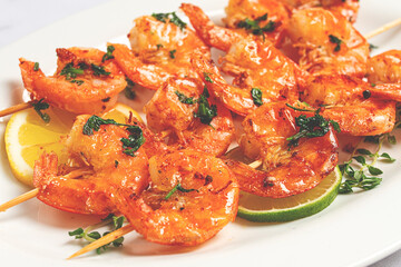 Fried shrimp, headless, on skewers, shrimp kebabs, with spices and herbs, grilled, homemade, without people,