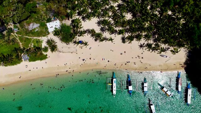 Seven commandos beach in El Nido, Palawan, Philippines islands. Aerial 4K drone video footage. Top view of beautiful turquoise beach, with white sand and palms
