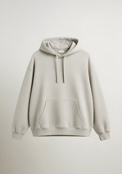 A neutral-toned, oversized hoodie displayed against a plain, light-colored background, showcasing its design.