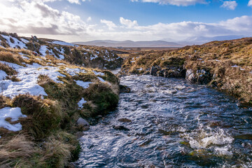 Wild stream in the winter mountains in the Northern Scottish Highlands