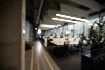 A blurry image of a group of people sitting at a table with laptops
